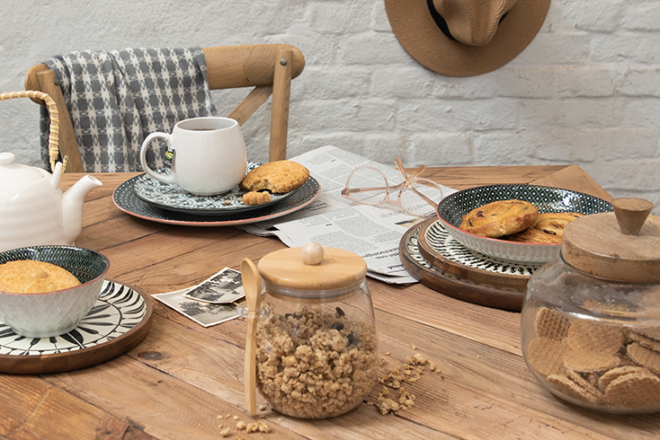 Rustic table filled with dishes and breakfast