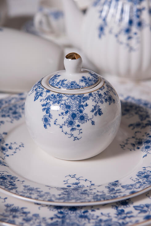 A white sugar bowl with blue flowers