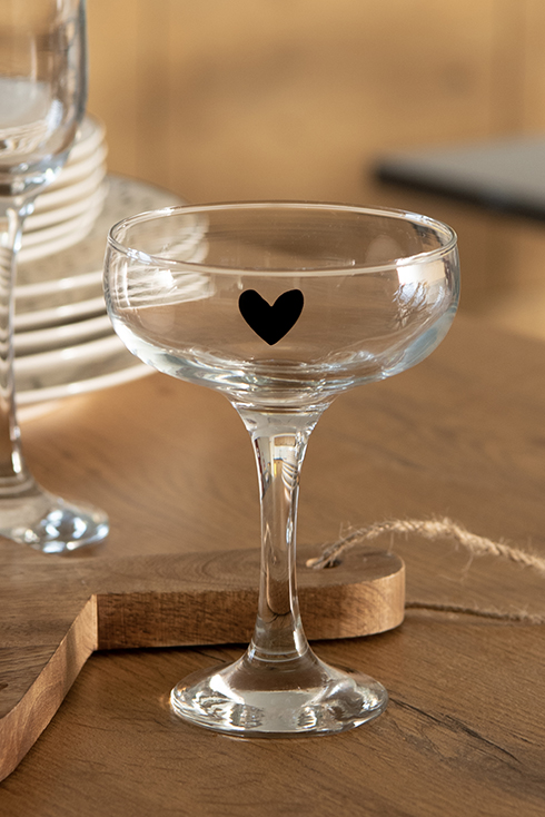A cocktail glass with a black heart