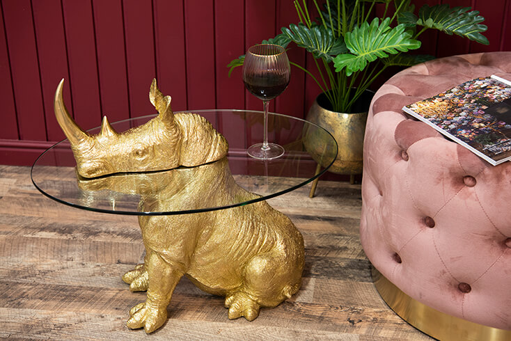 Une table basse en forme de rhinocéros avec un verre à vin dessus