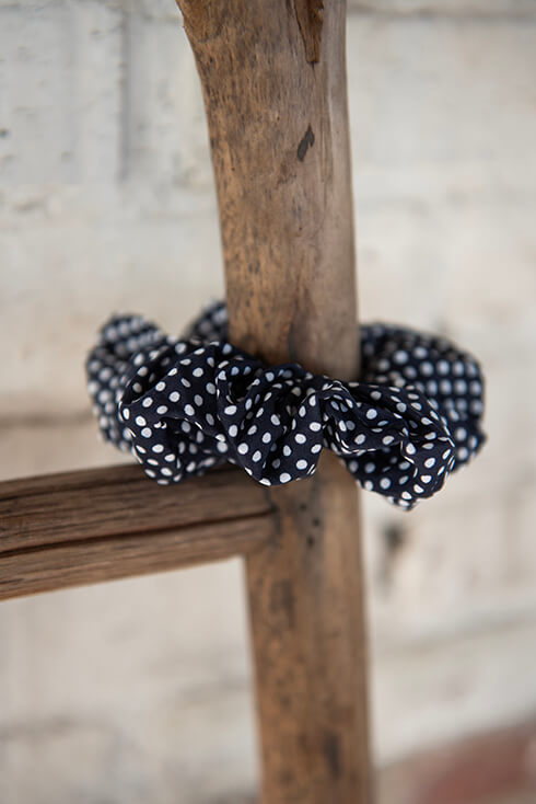 A blue scrunchie with white dots