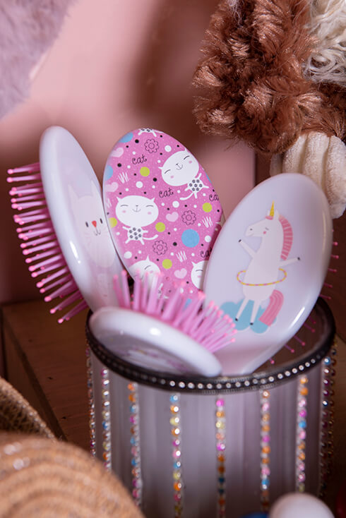 A collection of pink hairbrushes with a nice motif