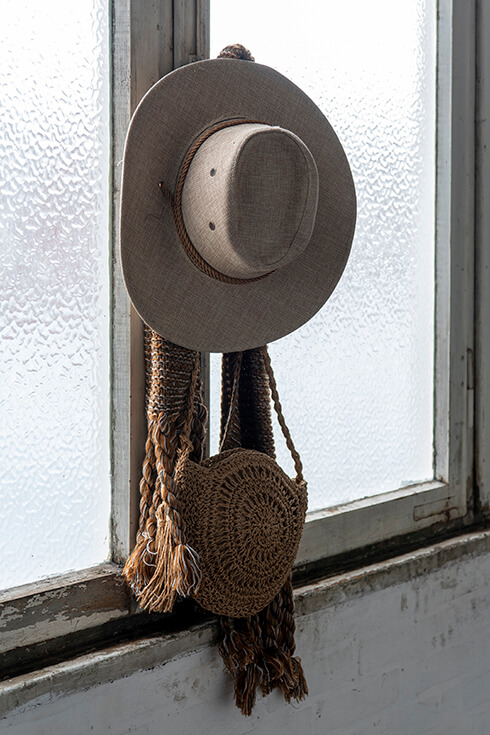 A cowboy hat with a wicker handbag