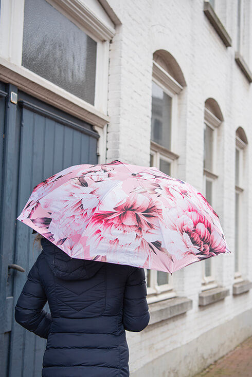 A pink umbrella with pink peonies
