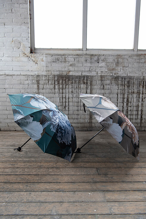 Two large umbrellas with antique flowers in blue and gray