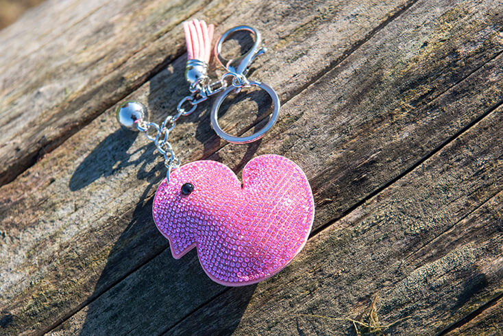 A pink key ring in the shape of a duck