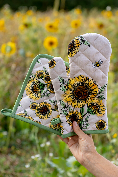 A sunflower-themed oven mitt and sunflower-themed pot holder