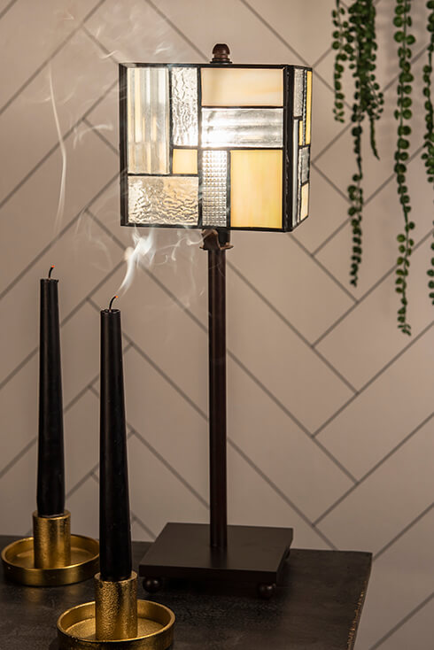 A geometric Tiffany table lamp with a modern black lamp base