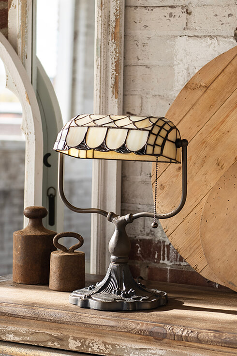 A Tiffany table lamp with beige colors in a rustic style