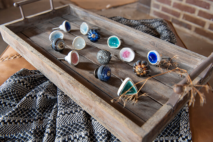 A wooden tray with a collection of cute doorknobs