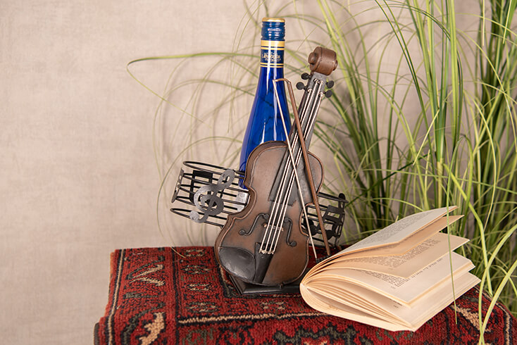 A violin with musical notes as a bottle rack