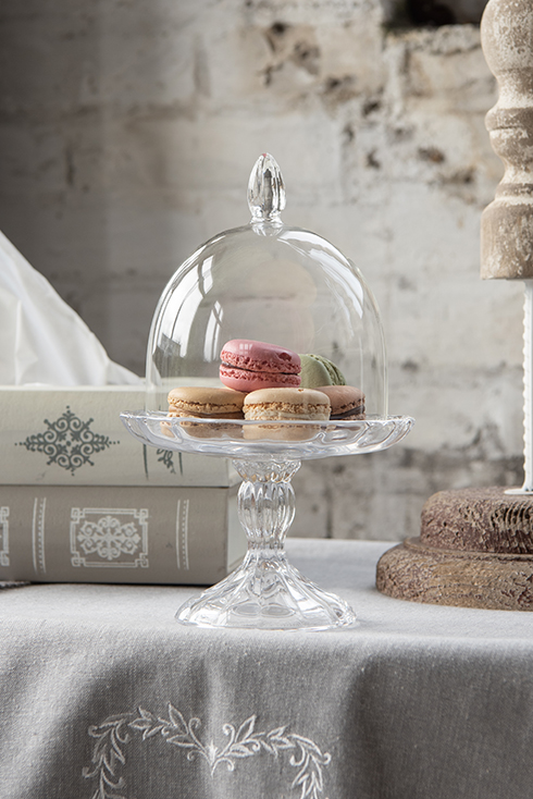 A glass bell jar with pastries