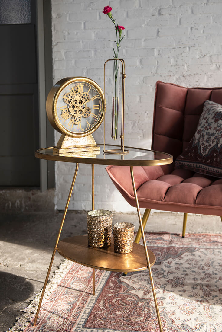 A modern side table with a table clock where gears are visible
