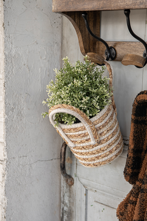 A basket with flowers on a coat rack